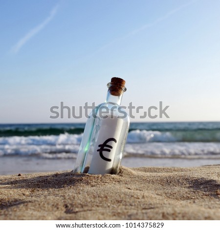 Bottle with euro icon inside on the beach, European currency