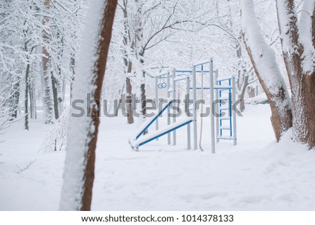 sport playground in winter under snow