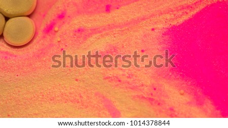 Colorful paint background in concept Fantasy luxury texture. Colors dropped into liquid and photographed while in motion. gold and pink circle abstract composition.
