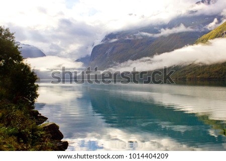 Beautiful norwegian landscape in autumn near Loen in Norway with lake and mountains. Lake surruonded by mountains. Lovatnet in autumn