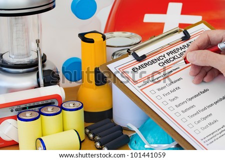 Hand completing Emergency Preparation List by Equipment Royalty-Free Stock Photo #101441059