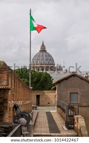 Italian flag in the wind with St. Peter Cupola in the background. Rome_italy