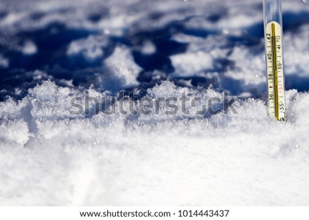 Thermometer in white fluffy snow