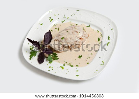 Grilled meat with white sauce decorated with bazilik