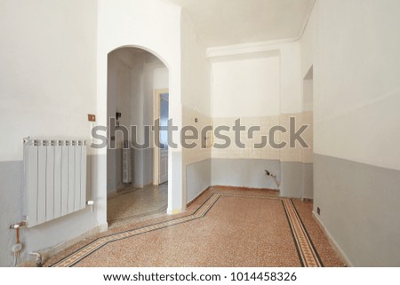 Empty living room and kitchern area interior in old apartment with tiled floor