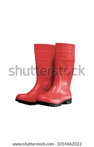 Rubber boots of red color on a white background to mean an industrial concept