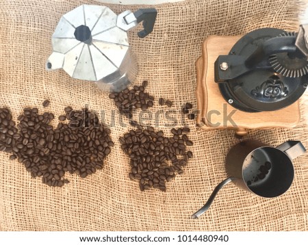 Coffee beans and equipment on brown sack textile background