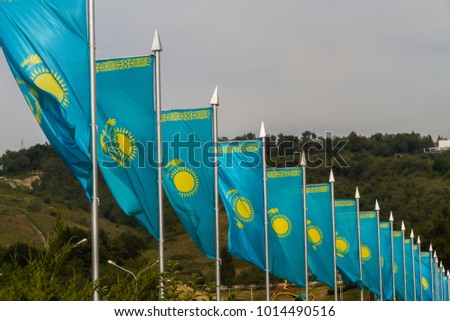 Line of blue and yellow Kazakh flags in wind, Almaty, Kazakhstan, Asia.