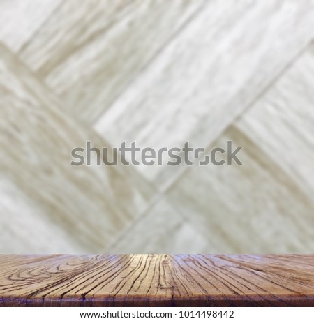Wood table top with blurred light and drak brown color wooden tile design for background - can be used for display or montage your products.