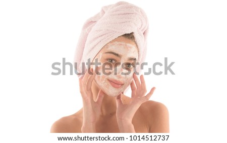 Beauty procedures skin care concept. Young woman applying facial mud clay mask to her face