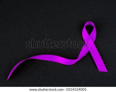 Purple ribbon awareness on black background  for World Cancer day.