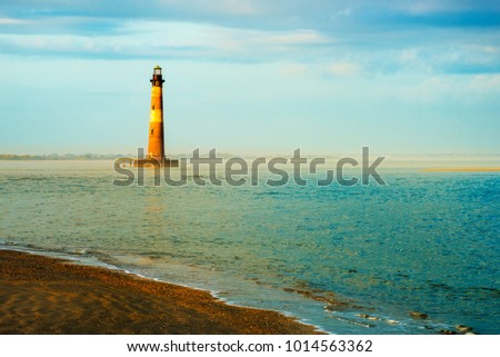 lighthouse in ocean near seashore