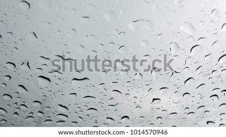 Water drops on glass close up, Rain droplets on glass background.