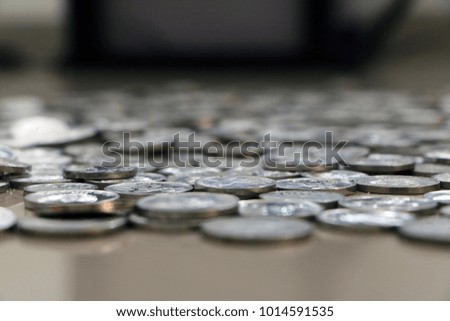 a stack of rupiah coins, indonesian currency