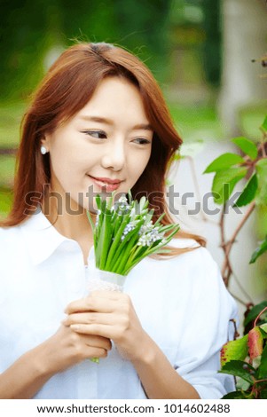 Korean woman holding flower bouquet