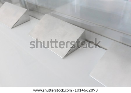 Modern Triangle Aluminum stand mockup for display on white table
