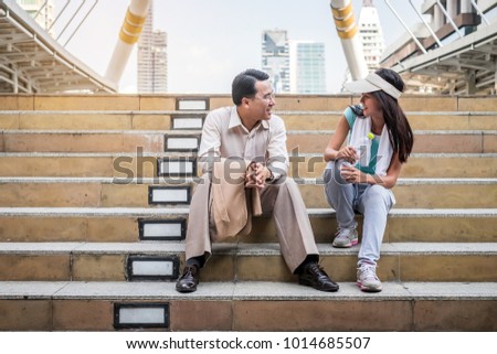 business startup man sitting outside office to talk with sport woman in the city, healthcare and relax concept
