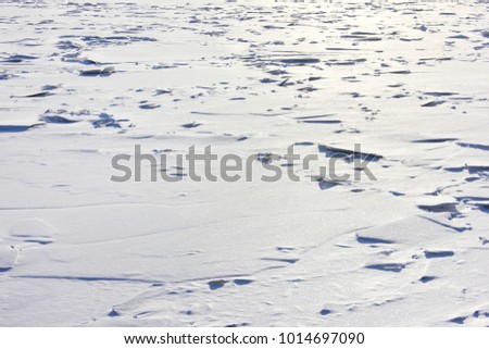 Winter Frozen River Ice-Covered Surface White Background. Frosty Landscape of Winter Nature, Ice on River Minimalistic Scenery. Icy Snow River View on Sunny Bright Winter Day Scene.