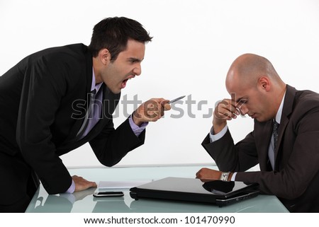 Businessman screaming at a colleague Royalty-Free Stock Photo #101470990