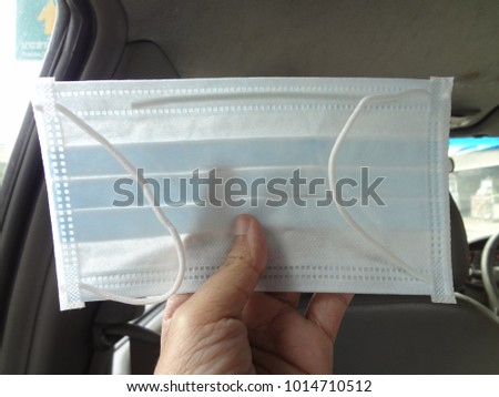 Medical Concept, Hand Holding Surgical Mask or Procedure Mask For Protection Against Bacteria Shed in Liquid Droplets and Aerosols in The Mouth and Nose.