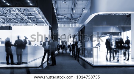 blurred people at a trade fair hall Royalty-Free Stock Photo #1014758755