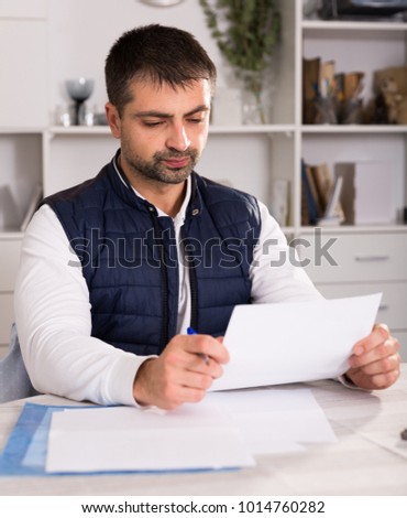 Sadly young man struggling to pay utility bills and home rent 
