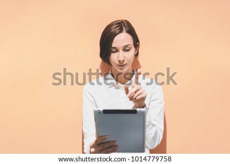Woman using a tablet PC (vivid background)