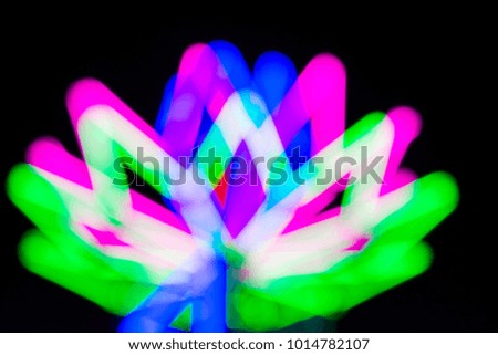 Blurred  green, purple, pink, white and blue light. 