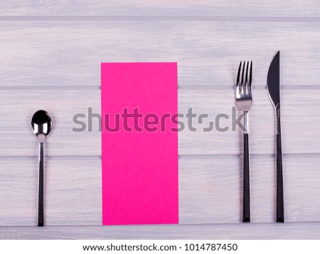 Empty pink paper between covered kitchen on wooden table. Menu. Food