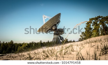 A huge soviet radio telescope near abandoned military town Irbene in Latvia Royalty-Free Stock Photo #1014791458