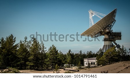 A huge soviet radio telescope near abandoned military town Irbene in Latvia Royalty-Free Stock Photo #1014791461