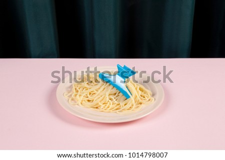 a delicious italian buttered spaghetti meal wearing a blue Hair Claw Clip. Minimal funny and quirky pop still life photography 