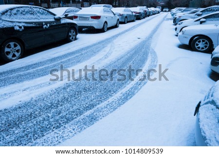 Cars covered with fresh snow.