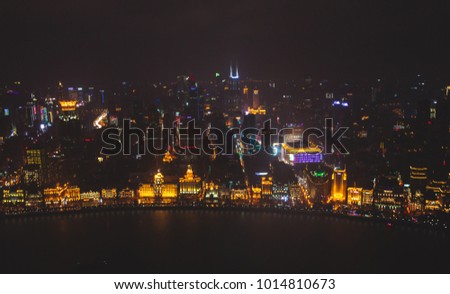 Beautiful super wide-angle night aerial view of Shanghai, China with Waitan, The Bund and scenery beyond the city, seen from the observation deck of Oriental Pearl TV Tower