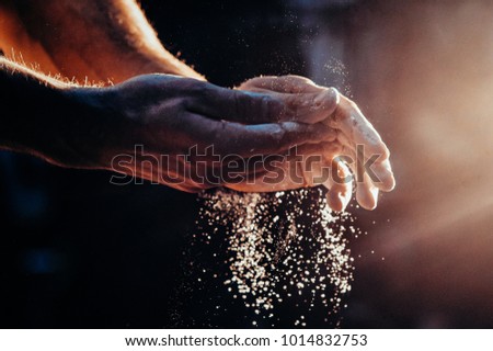 Male powerlifter hand in talc. palm preparation before lifting weights. Toned image. Hands in chalk. with the light different view Royalty-Free Stock Photo #1014832753