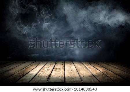 Table background of free space for your decoration and dark background of shadows and smoke. Desk place for your product or text. 