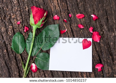 Red rose on wooden board with empty card.valentines day