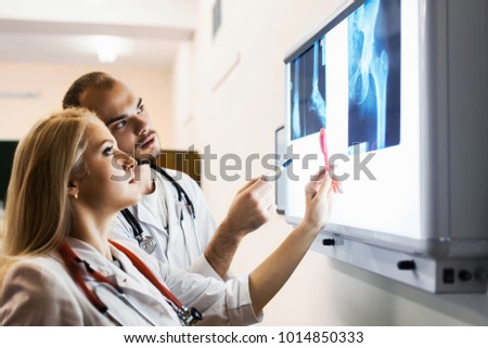 group medical workers man and woman examining x-ray photograph. concept spinal injury, hip, bones disabled child.