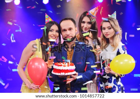 a guy and three girls rejoice and celebrate the party in the night club. Birthday, new year, corporate party, best friends