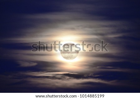 Full moon with cloudy sky.