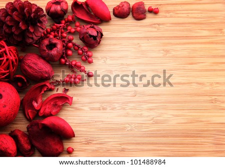  A red berry and fruit potpourri composition against a wooden background with copy space. Suitable for cards, invitations, advertising.