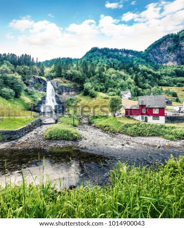 Awesome summer scene of waterfall Steinsdalsfossen on the Fosselva River. Picturesque evenig scene of  village of Steine, municipality of Kvam in Hordaland county, Norway. Orton Effect.

