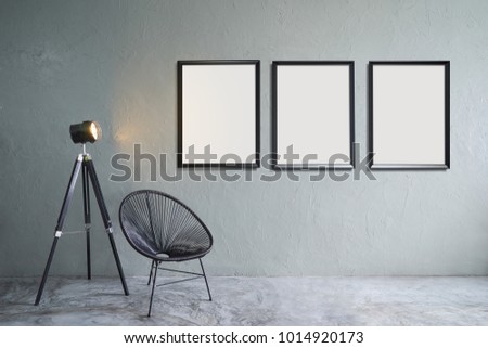 Modern living room with three empty picture frames ,black leisure chair ,green plant and lamp stand. cement floor and concrete wall , Interior design with Loft style .