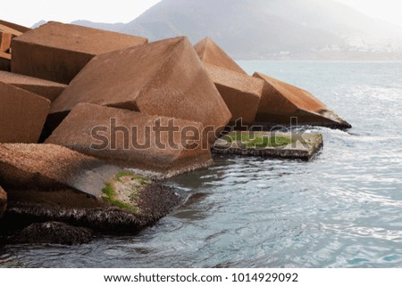 breakwater of large blocks of stone on the beach.