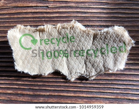 Recycling torn serviette on wooden background