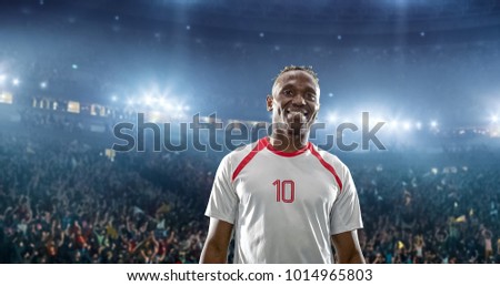 Happy soccer player celebrate a victory on a professional football stadium