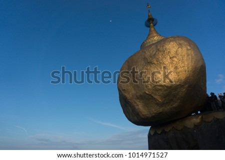 Golden rock, Kyaiktiyo pagoda with blue sky and moon background, Myanmar Burma