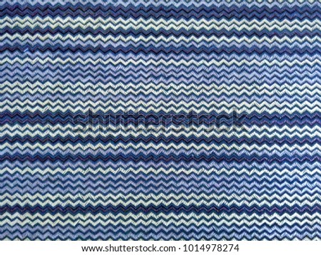 Background with zigzag distortion effect of a cloth fabric, textile with purple and white pattern.