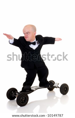 Little businessman, dwarf in a formal suit with bow tie surfing on skateboard, mountain board, studio shot, white background Royalty-Free Stock Photo #10149787