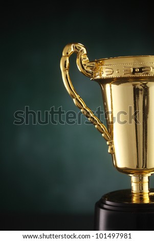 golden trophy on the green background